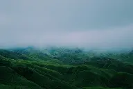 green mountains under cloudy sky